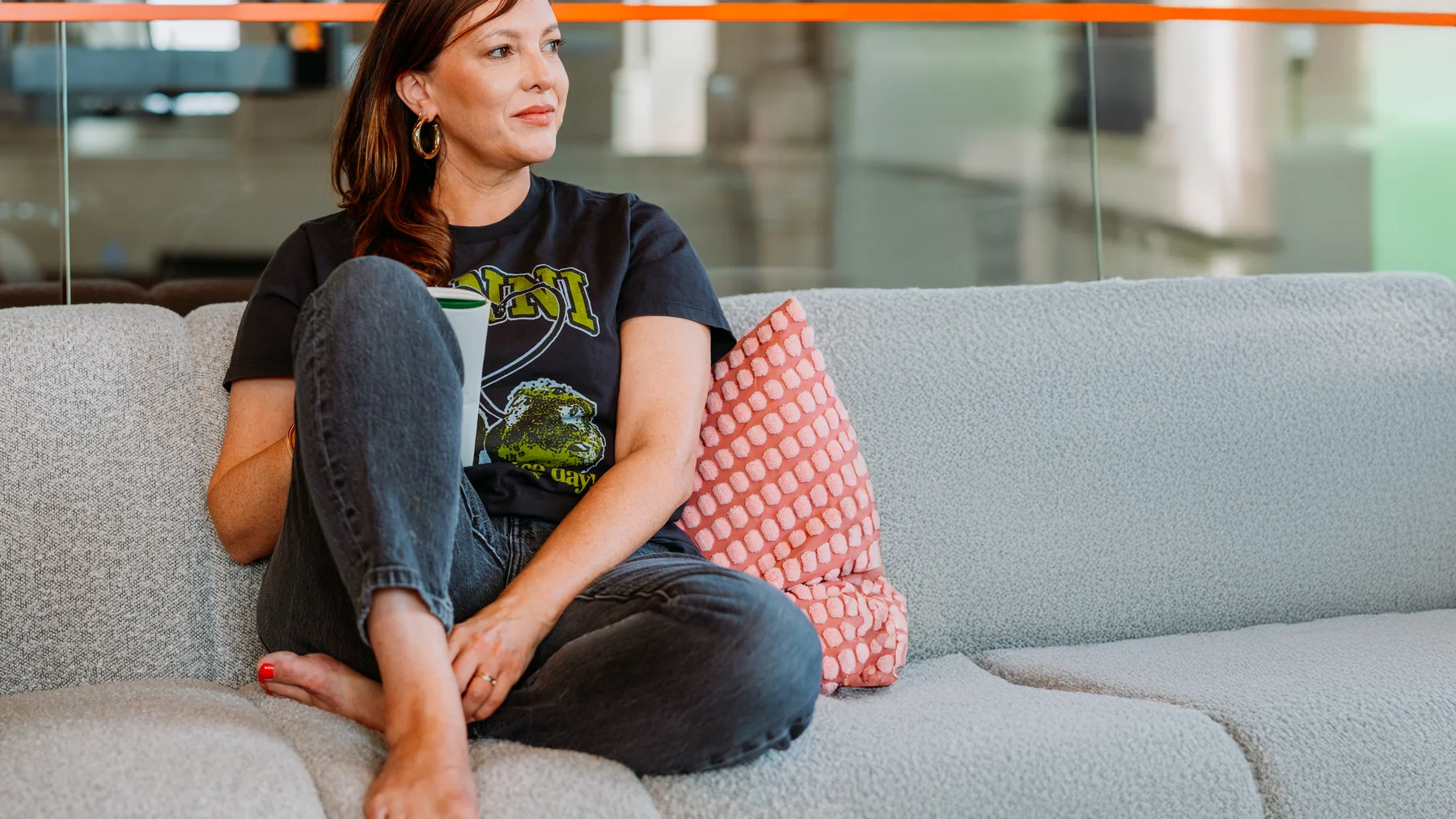 Kate Southerby sitting on a sofa in a relaxed coaching portrait